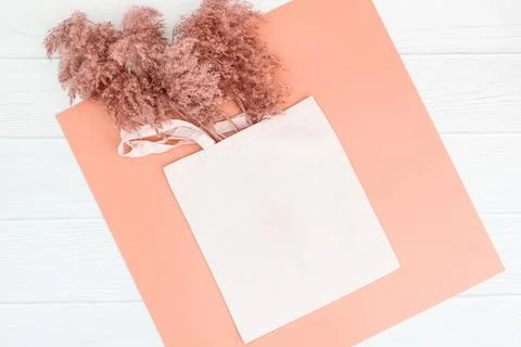 Fall mockup with tote bag blank and dry reeds on wood background Stock Photos