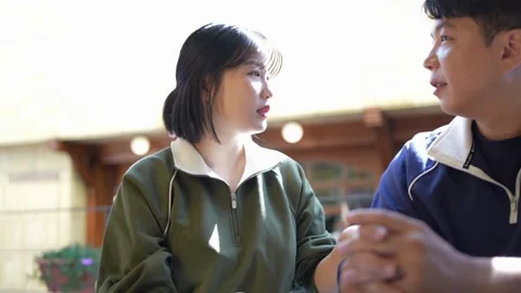 In the fall of October 2024, a young couple in tracksuits spends their time in a Stock Footage 292514254