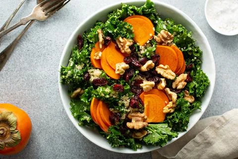 Fall or winter salad with persimmon and kale Stock Photos