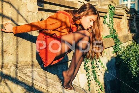Fall outfit. Modern fashion outfit. Autumn season. Pretty woman in skirt and Stock Photos