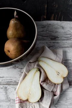Fall pears with slice in farmhouse setting Stock Photos