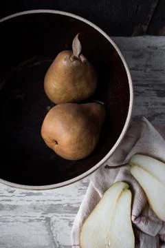 Fall pears with slice in farmhouse setting Stock Photos