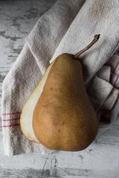 Fall pears with slice in farmhouse setting Stock Photos