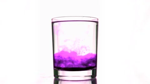 Fall of a purple ink stream into glass with pure water Video stock 154435459