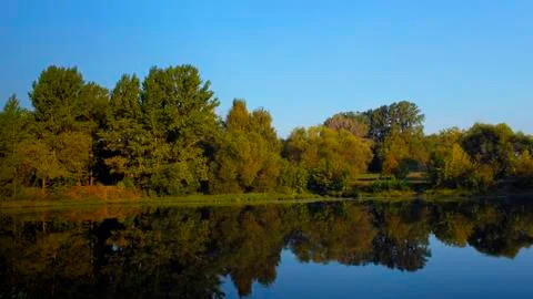 Fall reflection of trees in lake sunrise great view Stock Photos