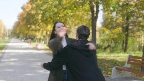Fall Romance Couple Smiling and Embracing in Scenic Park Stock Footage 303989884