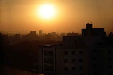The fall of the sun in the middle of the buildings of so paulo. The urban sky Stock Photos