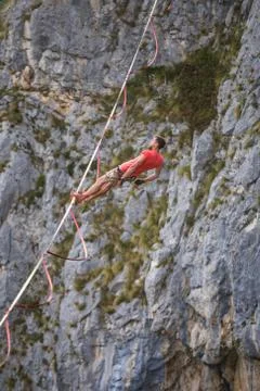 The fall of the tightrope walker. Highliner hanging on a sling. A man catches Stock Photos