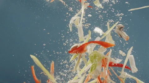 Fall vegetables in water on blue background. Cooking natural vegetables. Stock Footage 197768253