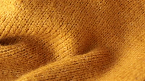 Fall warm knitted sweater close-up. Yellow wool material macro. Winter clothes Stock Footage 164731193