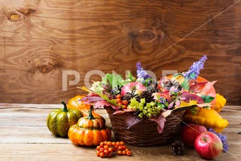 Fall wicker basket table centerpiece with blue flowers Stock Photos