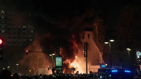 Falla burning with firefighter water hose during Las Fallas La Crema in Valencia Stock Footage 334294852