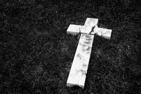 Fallen and broken down marble cross Stock Photos