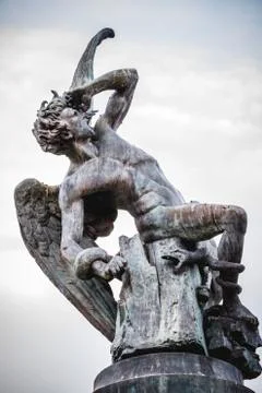 Fallen angel, devil figure, bronze sculpture with demonic gargoyles and monst Stock Photos
