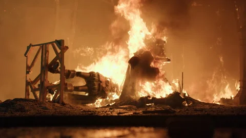 Fallen burning falla figures on ground during Las Fallas La Crema Stock Footage 336872734