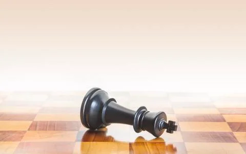 Fallen chess king as a metaphor for fall from power Stock Photos