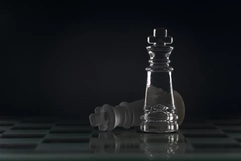 Fallen chess king as a metaphor for fall from power black background copy spa Stock Photos