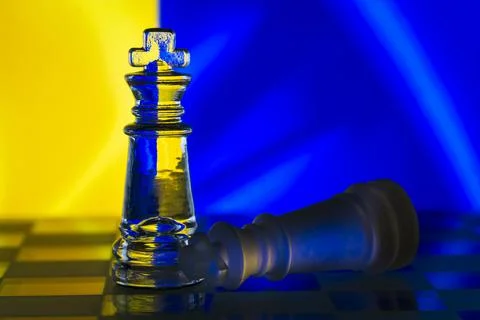 Fallen chess king as a metaphor for fall from power ukrainian flag background Stock Photos
