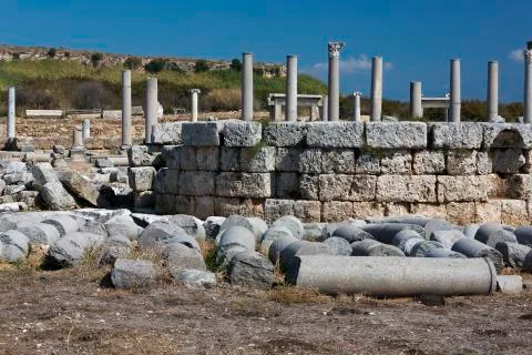 Fallen columns all pointing in the same direction. Stock Photos