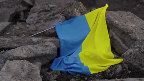 Fallen defeated Ukrainian flag in rubble laying on the ground war with russia Stock Footage 172201682
