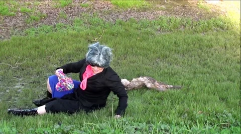Fallen Down Old Woman Sitting In Bottom of Ditch Rubbing Head Stock Footage 59972902