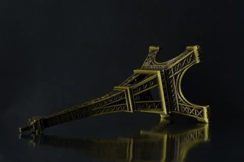 The fallen eiffel tower on a black background. Stock Photos