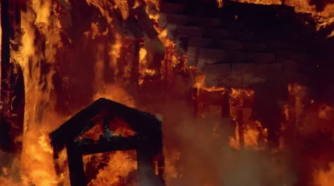 Fallen gable silhouetted against burning ruins of house Stock Footage 59240538