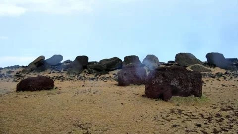 The fallen moai statues and Pukao at Ahu Vaihu, rainy weather, mid-November.. Stock Footage 333951096