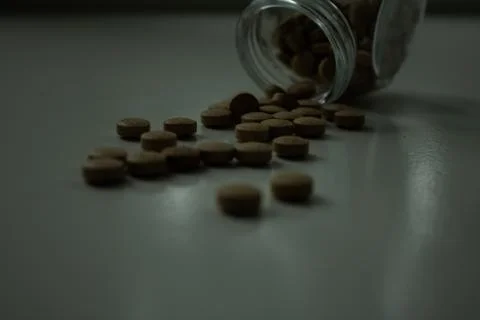 Fallen pills in the dark Stock Photos