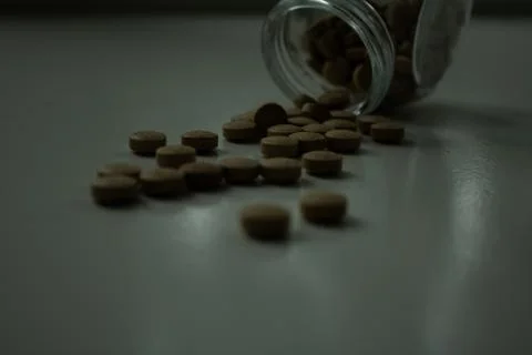 Fallen pills in the dark Stock Photos