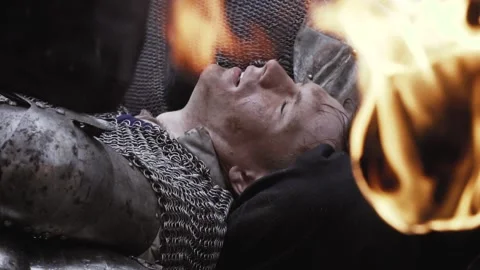 Fallen soldier in chainmail armor is lying on the ground Stock Footage 138425315