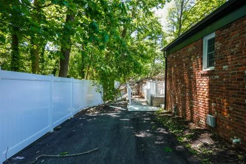 A fallen tree causing damage to a fence, ramp and backyard deck Stock Photos