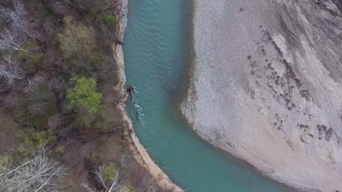 A fallen tree in a turquoise river. Top view Stock Footage 113136523