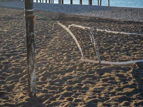 Fallen volleyball net on the beach. The concept of winter at the Black Sea .. Stock Photos