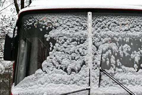 Fallen white snow on windshield of the bus Stock Photos