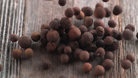 Falling allspice on wooden table. Slow Motion. Stock Footage 85072056