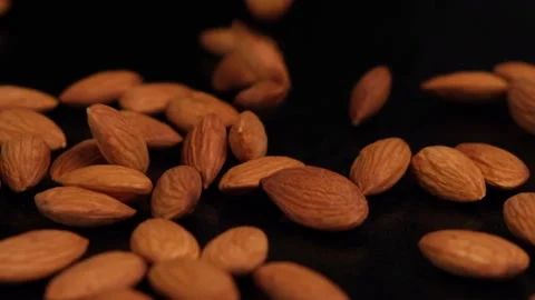 Falling almonds on black background Stock Footage 154631668