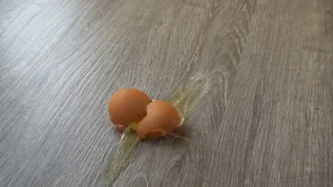 Falling and breaking an egg on laminate Stock Footage 77404624