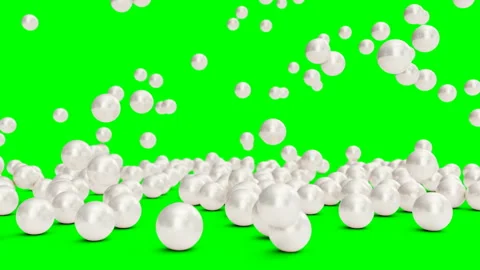 Falling and rolling pearls on a surface isolated on a green background. Jewelry Stock Footage 113335157