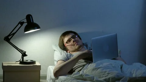 Falling asleep with laptop turned on. Video stock 147714056