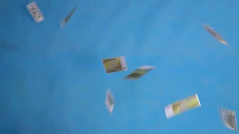 Falling banknotes dollars and euros on a blue background close up Stock Footage 124634993