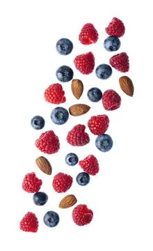 Falling berries with nuts on white backgrounds. Stock Photos