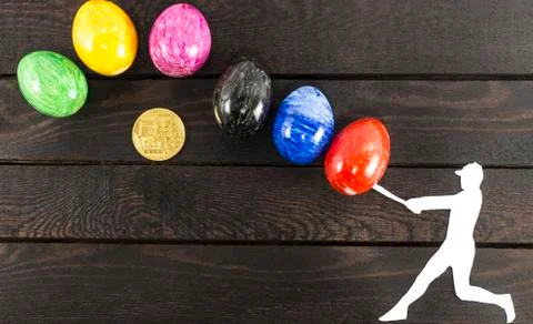 Falling bitcoin concept - baseball player hitting eggs. Stock Photos