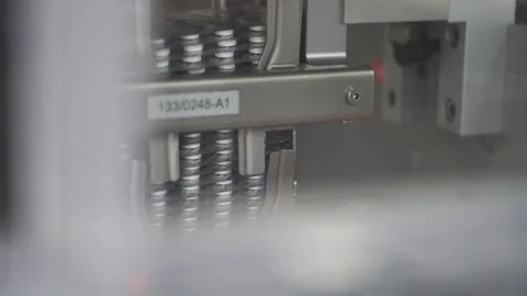 Falling blisters of pills, tablets on packaging conveyor on pharmaceutical plant Stock Footage 120418472