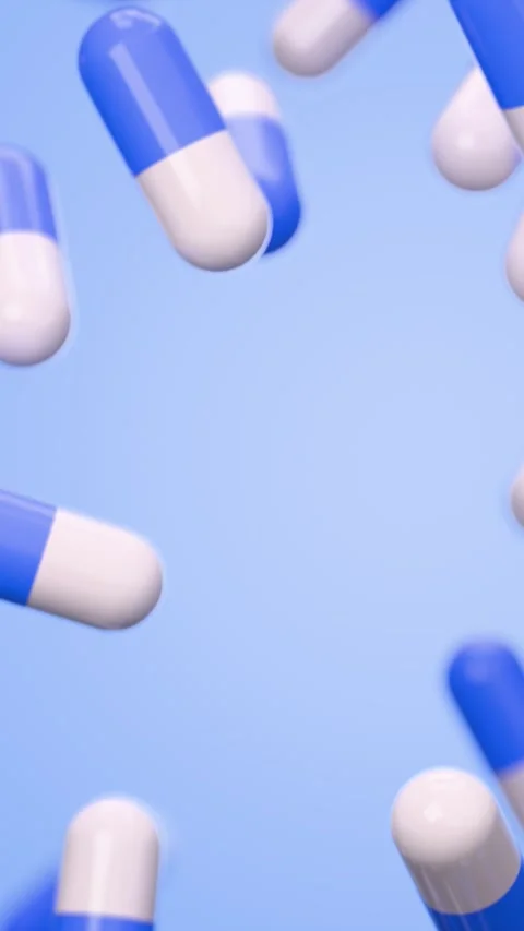 Falling blue and white capsule pills on blue background Видео 329924727