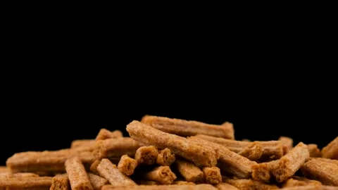 Falling breadcrumbs on a black background. The beer snack drops. Slow motion Stock Footage 135678311