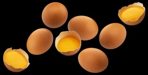 Falling brown chicken eggs, black background, package design element Stock Photos