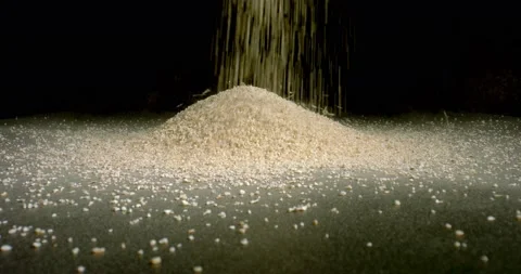 Falling brown sugar forms a mound. Brown sugar is pouring on table making a heap Stock Footage 146507563