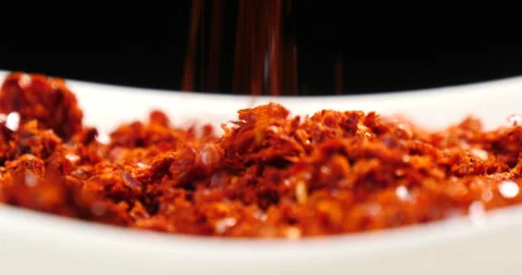 Falling chilli powder on a dish Stock Footage 162613836