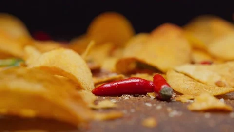 Falling chips and chili peppers, food porn, 120fps, 2.6k Stock Footage 130799871
